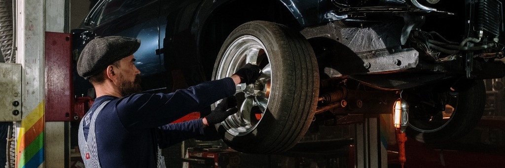 Professional technician performing alloy wheel repair on a kerbed rim in the UK